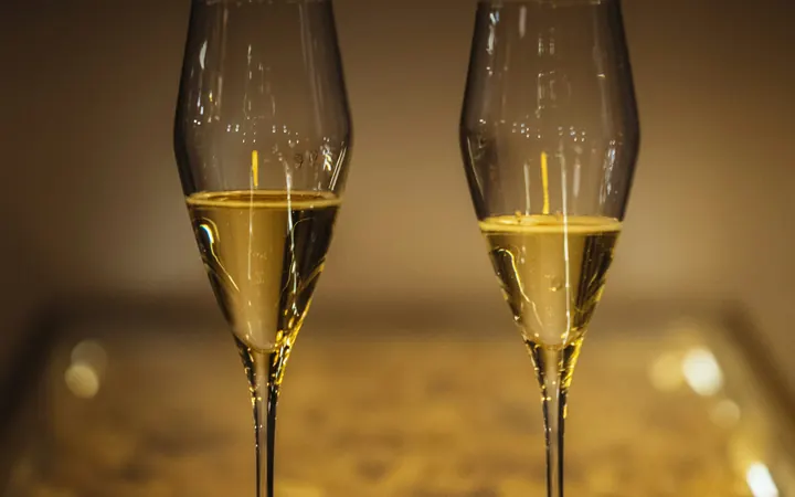 Two glasses of champagne on a golden table