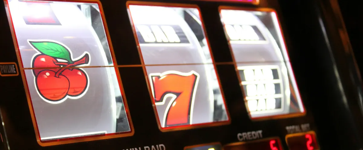Classic slot reels showing a cherry and a lucky seven